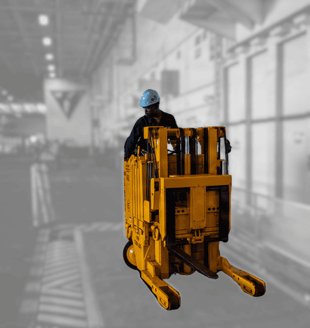 Employee utilizing lifting equipment in blurred factory setting